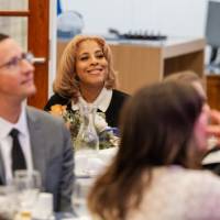 Khadijah Johnson smiles at her table during dinner